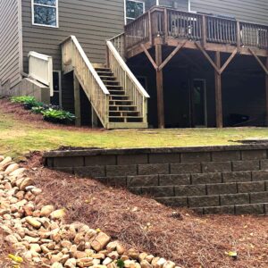 Landscape drainage solutions in Atlanta include strategically placed retaining walls, native vegetation and Dry Creek beds