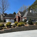 Beautifully landscaped Alpharetta residential property showing retaining wall and concrete driveway