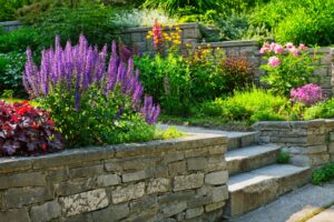 Beautiful landscaped garden with natural stone wall and flower garden