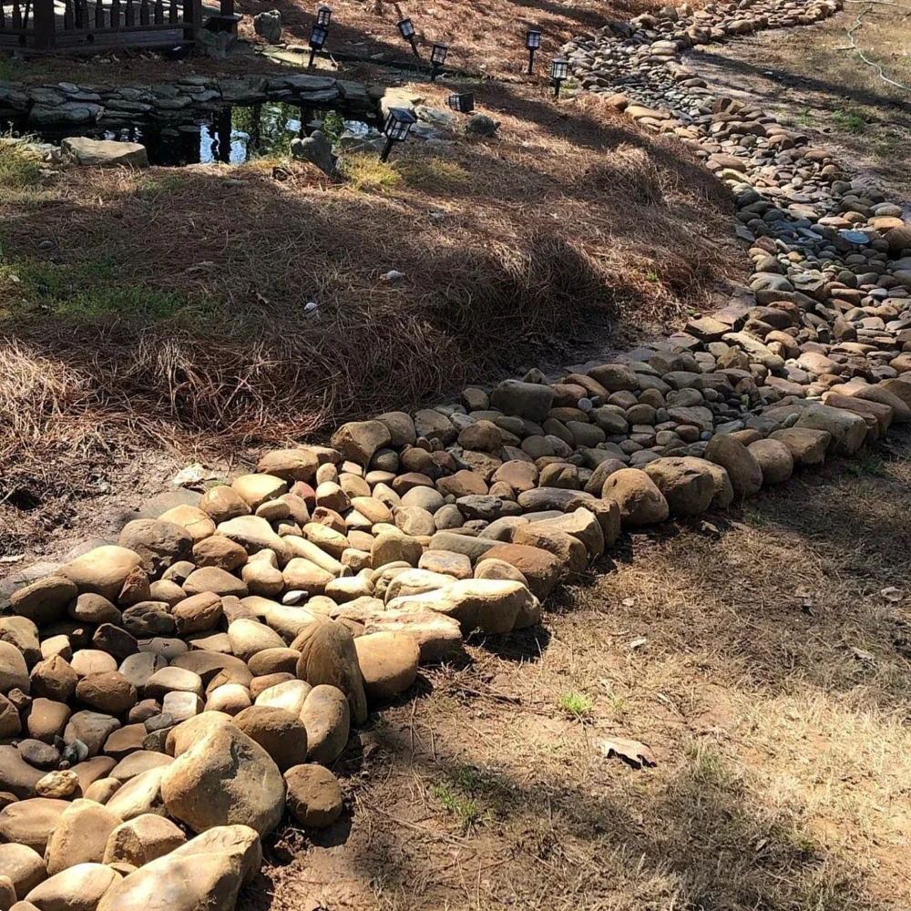 Landscape drainage solutions in Atlanta include dry creek beds and retaining walls