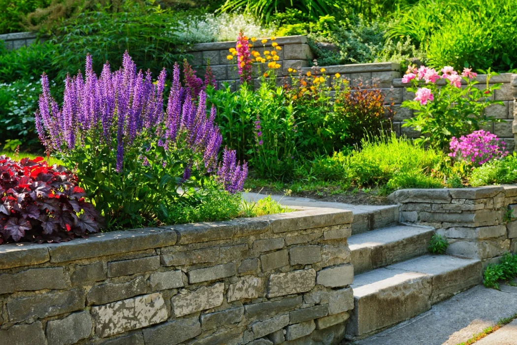 Beautiful landscaped garden with natural stone wall and flower garden